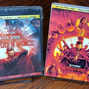 May include: Two Blu-ray movie cases for "Doctor Strange in the Multiverse of Madness." The cases feature vibrant artwork with Doctor Strange in a red cloak. The text "4K Ultra HD + Blu-ray + Digital Code" is visible on the top of the cases.