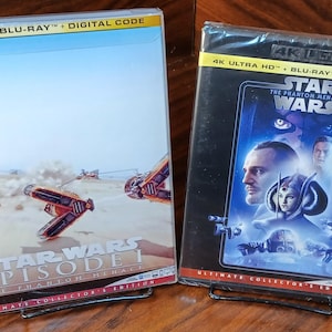 May include: A white ceramic mug with a black handle and the text "But First, Coffee" in a black, bold font. The mug is likely 4 inches tall and holds approximately 12 ounces of liquid.