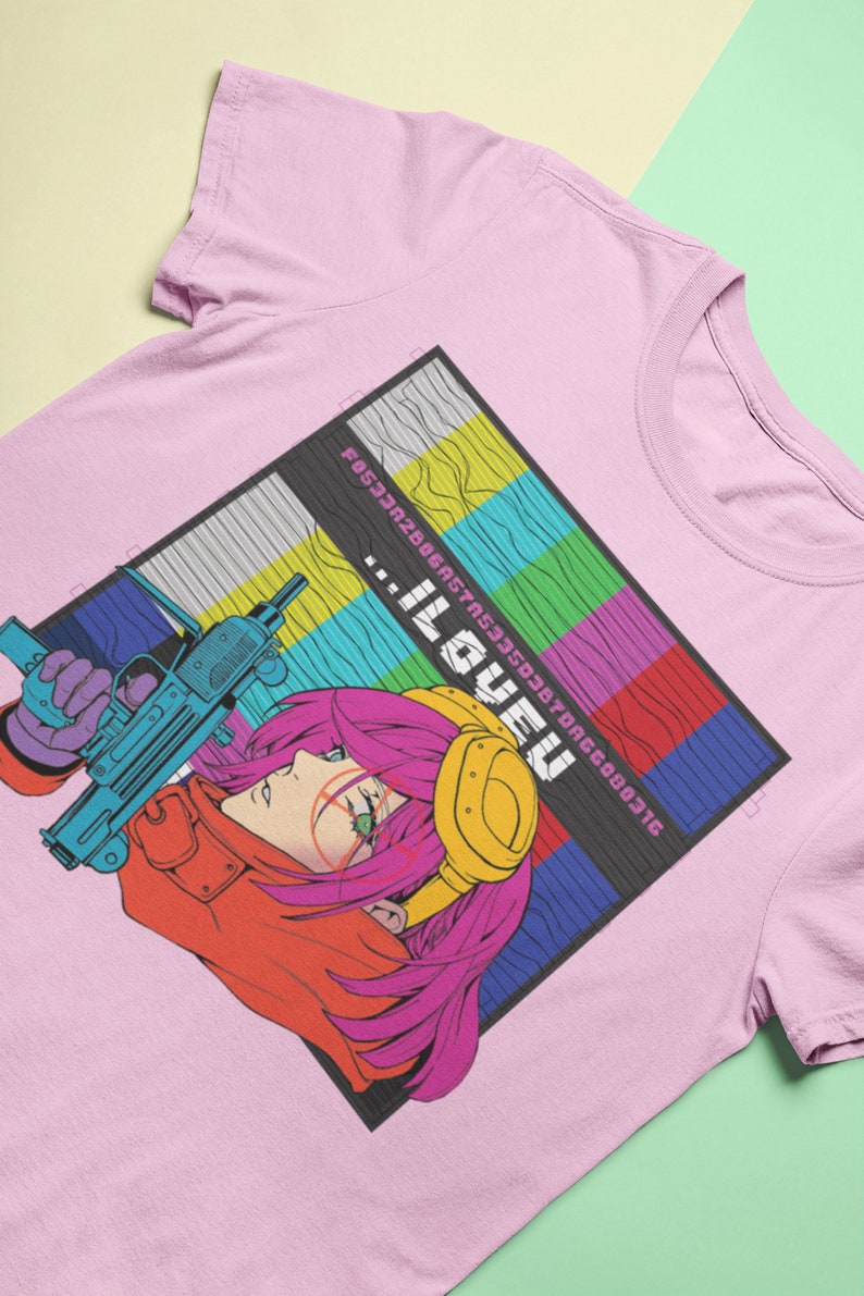 May include: Pink t-shirt with a graphic of a woman with pink hair holding a gun. The graphic is in a retro style with a pixelated background and the text "...ILOVEU" in a pixelated font.