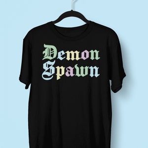 May include: Black t-shirt with the text "Demon Spawn" in a colorful gothic font.