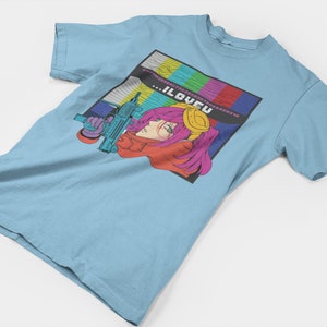 May include: A light blue t-shirt with a graphic print of a woman with pink hair holding a gun. The graphic is set against a colorful background of a television screen with the text "...ILOVEU" in the center.