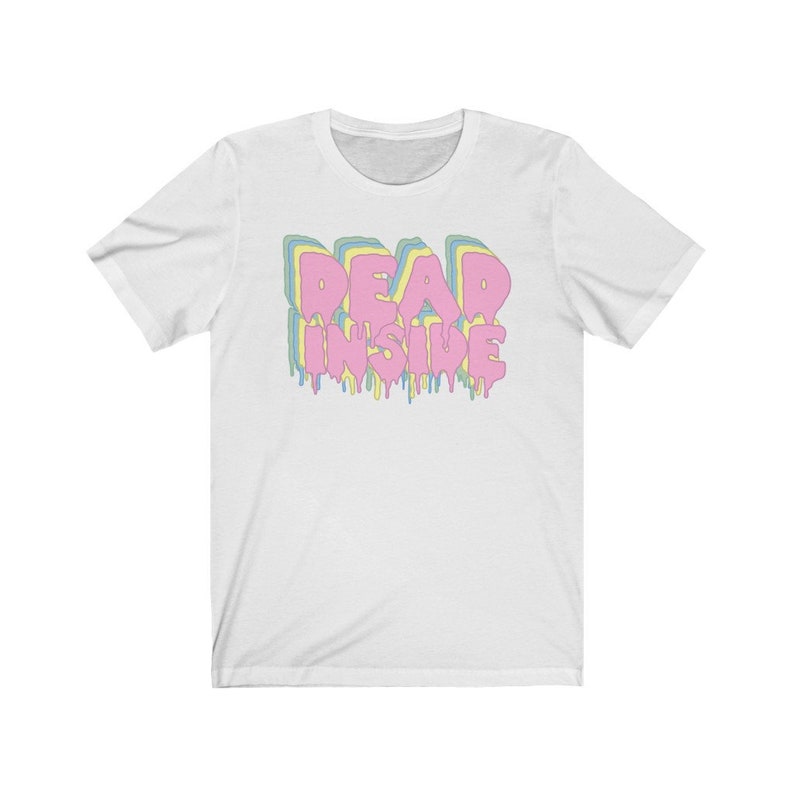 May include: White t-shirt with the text "DEAD INSIDE" in a layered, dripping font. The text features pastel colors: pink, yellow, blue, and green. The shirt is a crew neck style.