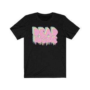 May include: Black t-shirt with the text "DEAD INSIDE" in a layered, dripping font. The text features pastel colors including pink, yellow, and blue. The shirt is a short-sleeved crew neck.