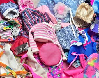 May include: A collection of colorful fabric scraps, including pink, blue, and white, with a variety of patterns and textures. There are also several accessories, such as a hat, a purse, and a belt. The fabric scraps are arranged in a random pattern, creating a visually appealing and interesting image.