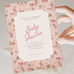 May include: A pink floral baby shower invitation with the text "Join us to celebrate Olivia Collin's Baby Shower" and details about the event, including the date, time, location, and RSVP information. The invitation also includes the text "Please wear pink."