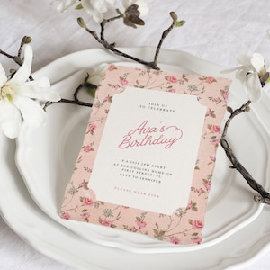 May include: A pink floral patterned invitation card with a white border. The text on the card reads "Join us to celebrate Ava's Birthday 4.6.2024 2PM Start at the Collins Home on First Street, FL RSVP to Jennifer Please wear pink."