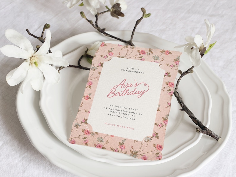 May include: A pink floral patterned invitation card with a white border. The text on the card reads "Join us to celebrate Ava's Birthday 4.6.2024 2PM Start at the Collins Home on First Street, FL RSVP to Jennifer Please wear pink."