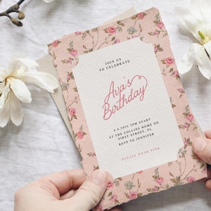 May include: A pink floral patterned invitation card with the text "Join us to celebrate Ava's Birthday" and details for the event. The text "Please wear pink" is at the bottom of the card.