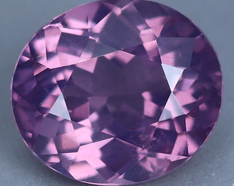 May include: A faceted, oval-shaped gemstone with a purple hue. The gemstone has a high degree of clarity and brilliance.