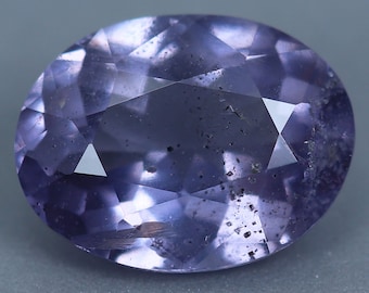 May include: A purple gemstone with a faceted cut and a slightly cloudy appearance.