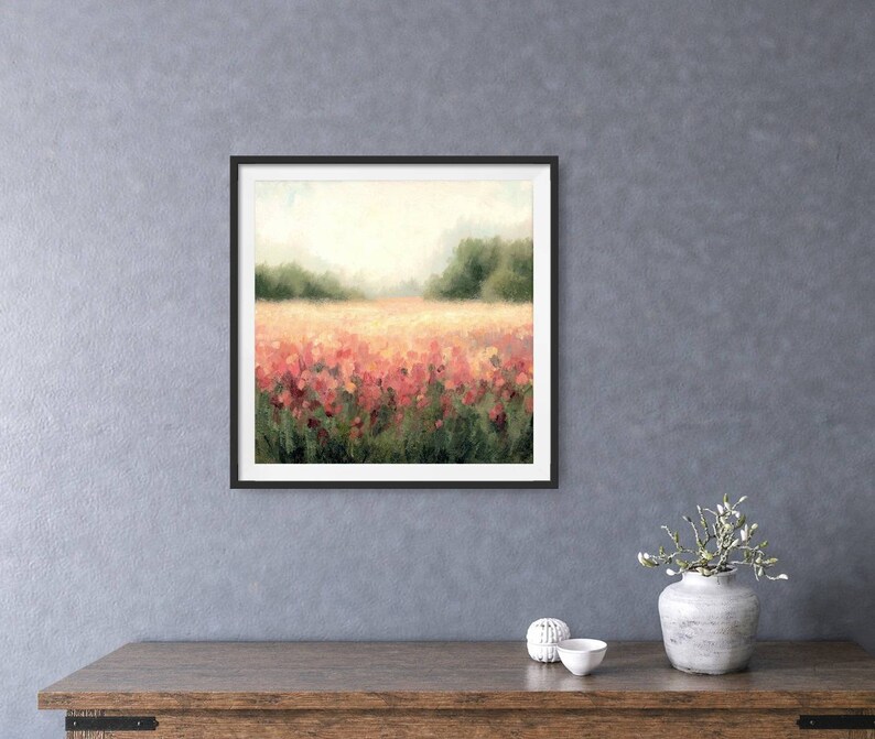 May include: A framed painting of a field of pink flowers with a blurred background of trees and a hazy sky.