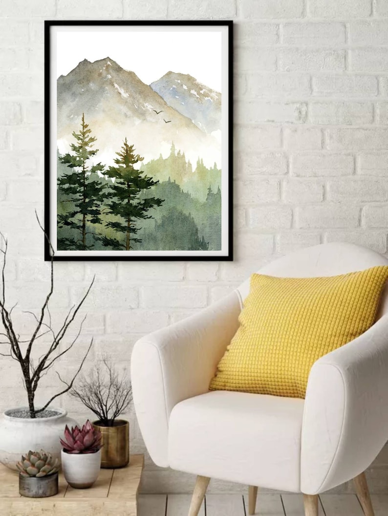 May include: A watercolor painting of a mountain landscape with a forest in the foreground. The mountains are a light gray color with a hint of blue, and the forest is a deep green. The sky is a light blue with a few white clouds.