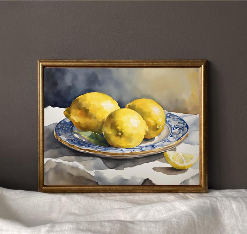 May include: Watercolor painting of three yellow lemons on a blue and white patterned plate. The lemons are arranged in a cluster, with one lemon slightly overlapping the others. The plate is sitting on a white tablecloth.