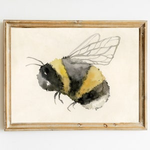 May include: Watercolor painting of a bumblebee with yellow and black stripes and translucent wings in a wooden frame.