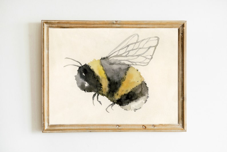 May include: Watercolor painting of a bumblebee with yellow and black stripes and translucent wings in a wooden frame.