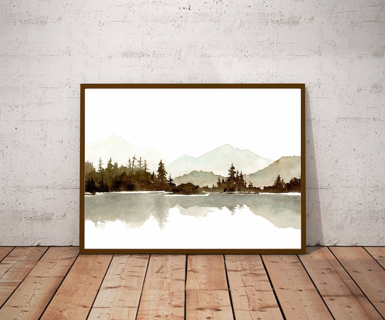 May include: A watercolour painting of a mountain range reflected in a still lake. The mountains are a light grey colour, and the lake is a light blue colour. The trees are a dark green colour and are silhouetted against the mountains.