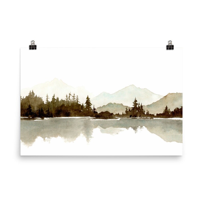 May include: A watercolour painting of a mountain range reflected in a still lake. The mountains are a light blue and grey, and the lake is a light grey. The trees are a dark brown and green.