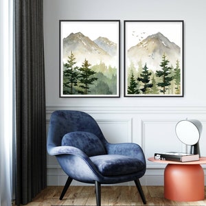 Puede incluir: Dos pinturas de acuarela enmarcadas de una cordillera con un bosque en primer plano. Las pinturas est&aacute;n en tonos de verde, marr&oacute;n y blanco. Las pinturas est&aacute;n colgadas en una pared blanca.