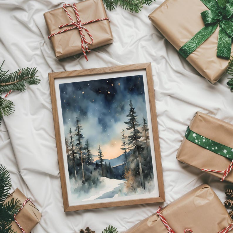 May include: A framed watercolor painting of a snowy forest scene with a starry night sky. The painting features a path leading through the trees towards a distant mountain range with a sunset in the background.