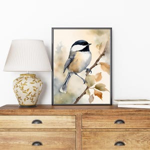 May include: Watercolor painting of a black-capped chickadee perched on a branch with brown and yellow leaves. The bird is facing right and has a white breast, black cap, and gray wings.