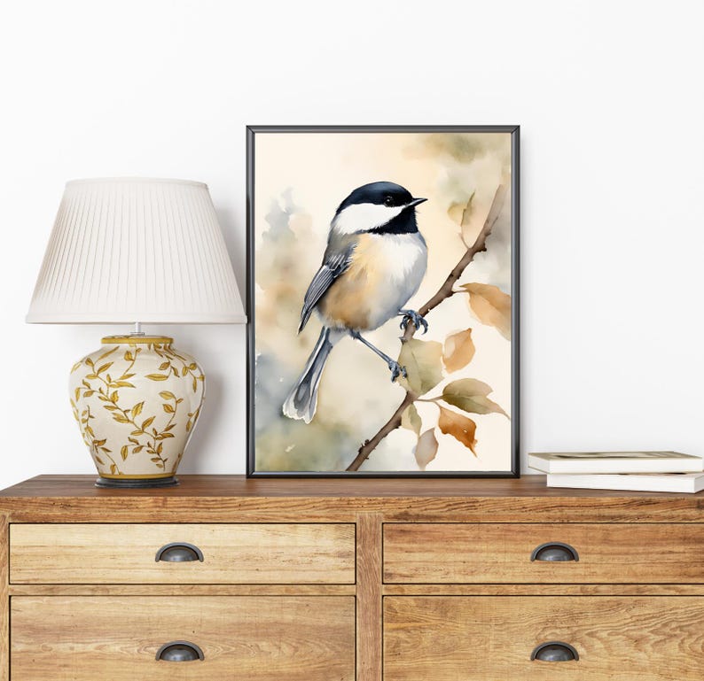 May include: Watercolor painting of a black-capped chickadee perched on a branch with brown and yellow leaves. The bird is facing right and has a white breast, black cap, and gray wings.