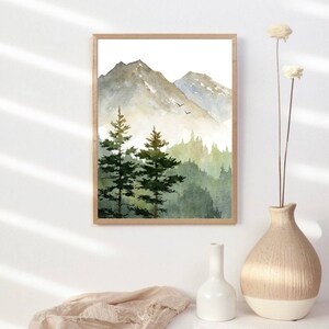 May include: A watercolor painting of a mountain range with two pine trees in the foreground. The mountains are a light brown color and the trees are a dark green. The sky is a light blue color and there are two birds flying in the sky.