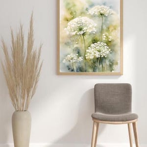 May include: A watercolour painting of white Queen Anne's Lace flowers with green stems and leaves against a soft yellow and blue background.