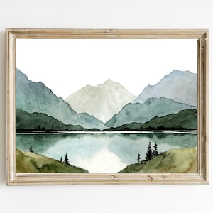 May include: Watercolor painting of a mountain range with a lake in the foreground. The mountains are painted in shades of green and blue, and the lake is a deep blue. The painting is framed in a light wood frame.