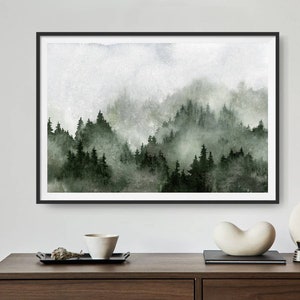 May include: A framed watercolour painting of a misty forest scene with green trees and a white background.