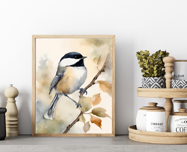May include: Watercolor painting of a black-capped chickadee perched on a branch with fall leaves. The bird is painted in realistic detail with a soft, muted color palette.