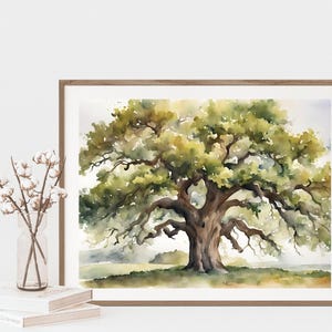 May include: Watercolor painting of a large oak tree with sprawling branches and lush green foliage. The artwork is framed in a light brown wooden frame. The painting is displayed on a white surface with books and a vase of flowers.