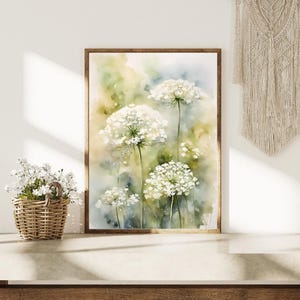 May include: Watercolour painting of white Queen Anne's Lace flowers with green stems and leaves on a light blue and yellow background.