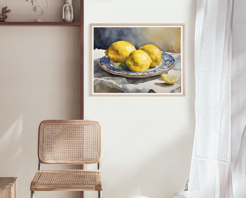 May include: Watercolor painting of three yellow lemons on a blue and white patterned plate. The lemons are arranged in a still life composition on a white tablecloth.