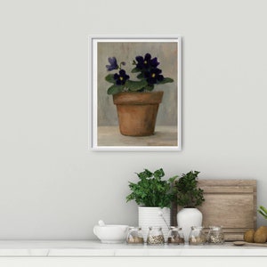 May include: A painting of a potted violet plant with dark purple flowers and green leaves. The plant is in a terracotta pot and is sitting on a table.