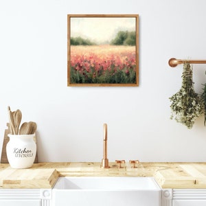 May include: A framed painting of a field of pink flowers with a blurred background of trees and a hazy sky.