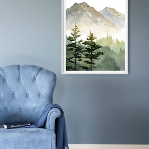 May include: A watercolor painting of a mountain range with two pine trees in the foreground. The mountains are a light gray color with a hint of green, and the trees are a dark green. The background is a light blue color.