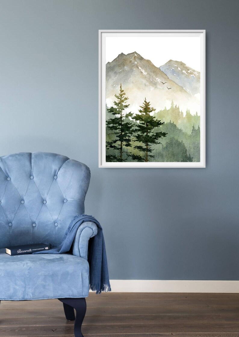 May include: A watercolor painting of a mountain range with two pine trees in the foreground. The mountains are a light gray color with a hint of green, and the trees are a dark green. The background is a light blue color.