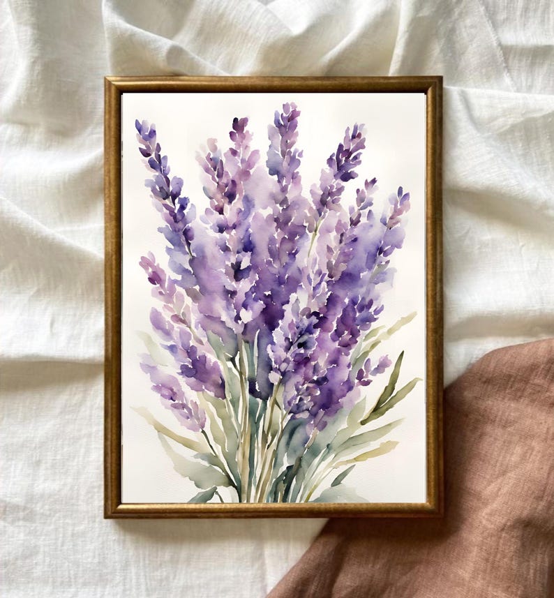 May include: A framed watercolour painting of lavender flowers. The artwork features a bouquet of purple lavender blossoms with green leaves, set against a white background. The frame is a warm gold colour.