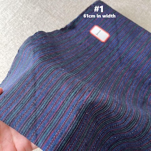 May include: Striped fabric in shades of blue, green, and red. The fabric is 61 inches wide.