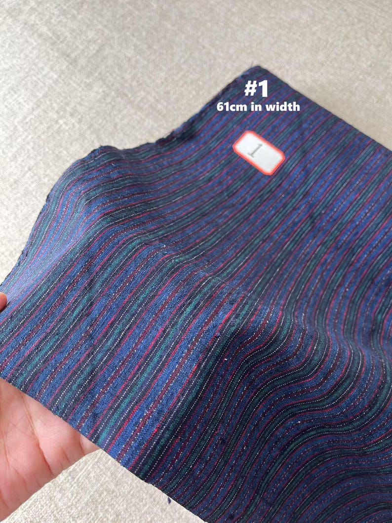 May include: Striped fabric in shades of blue, green, and red. The fabric is 61 inches wide.