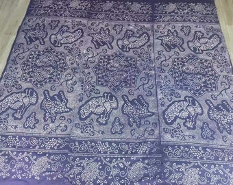 May include: A dark blue fabric with a white pattern of stylized birds and floral designs. The fabric has a repeating pattern and is made of a soft, textured material.