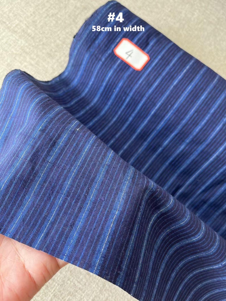 May include: Blue and white striped fabric with a label that says "#4 58cm in width".