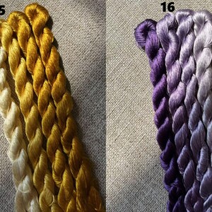Pode incluir: Tr&ecirc;s novelos de fio para bordar, um branco, um amarelo e um dourado. Os novelos est&atilde;o etiquetados com o n&uacute;mero 15.