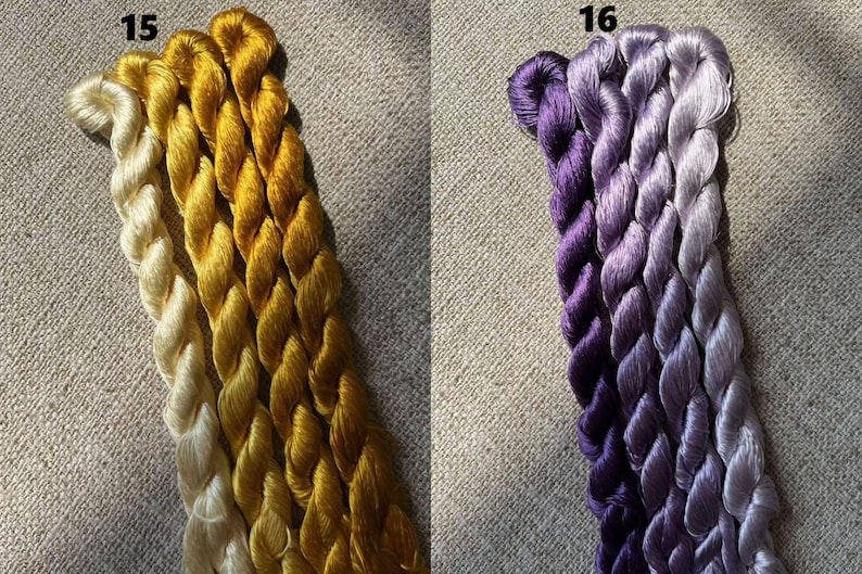 Pode incluir: Tr&ecirc;s novelos de fio para bordar, um branco, um amarelo e um dourado. Os novelos est&atilde;o etiquetados com o n&uacute;mero 15.