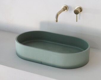 Large oval green concrete sink