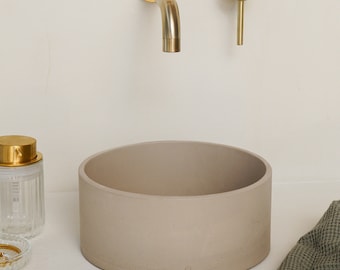 Small mineral concrete basin with rope