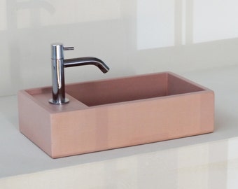 Pink concrete hand wash basin