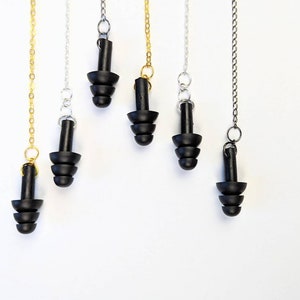 May include: Five pairs of black silicone earplugs with a chain attached. The chains are gold, silver, and black.