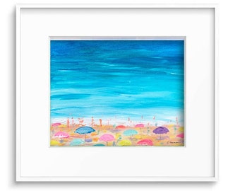 May include: A framed painting of a beach scene. The artwork depicts a bright blue sky and turquoise water. Colorful beach umbrellas dot the sandy shore. The painting is in a white frame.
