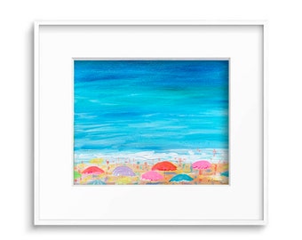 May include: A painting of a beach scene with colorful umbrellas and people in the distance. The sky is blue and the water is turquoise. The painting is framed in white.